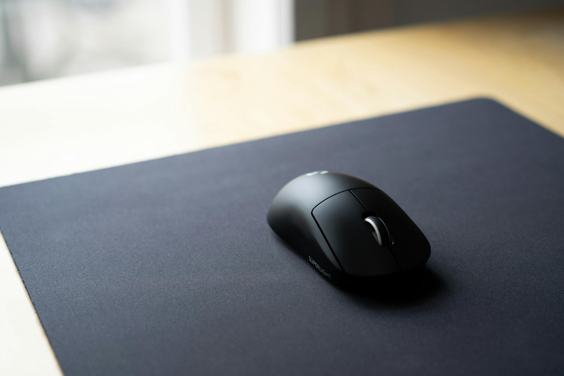 a black mouse on a mouse pad